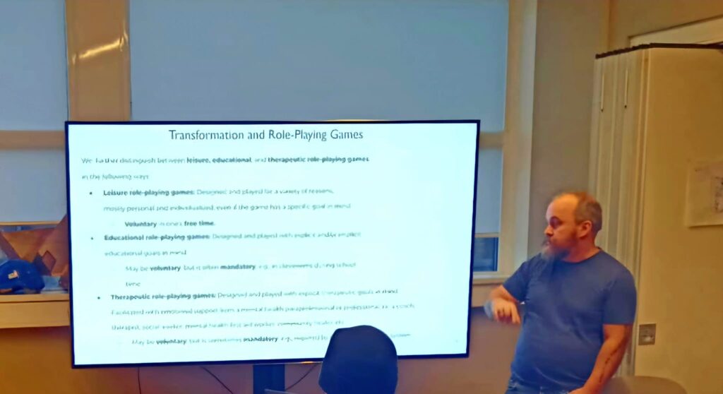 Photo of Kjell Hedgard Hugaas presenting concepts in transformative role-playing game design